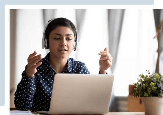A woman student on a computer and on a video call with other students.