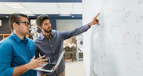 Two male Master of Data Science students working on a project for school.