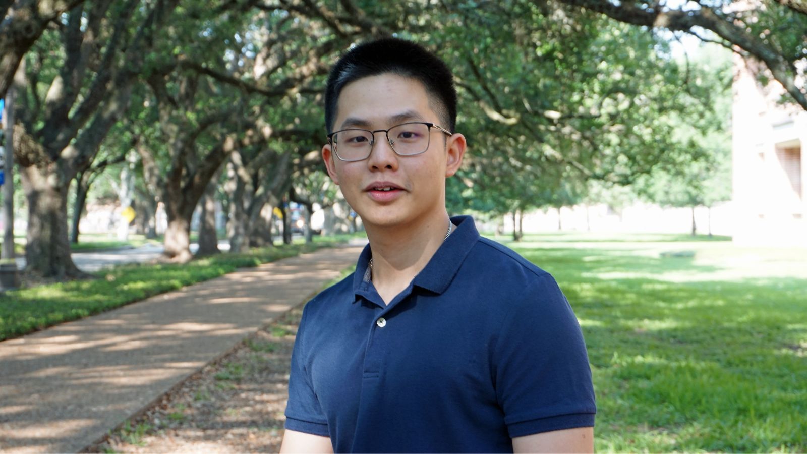 Rice CS PhD Student Patrick Kon standing outside Duncan Hall on the Rice University campus